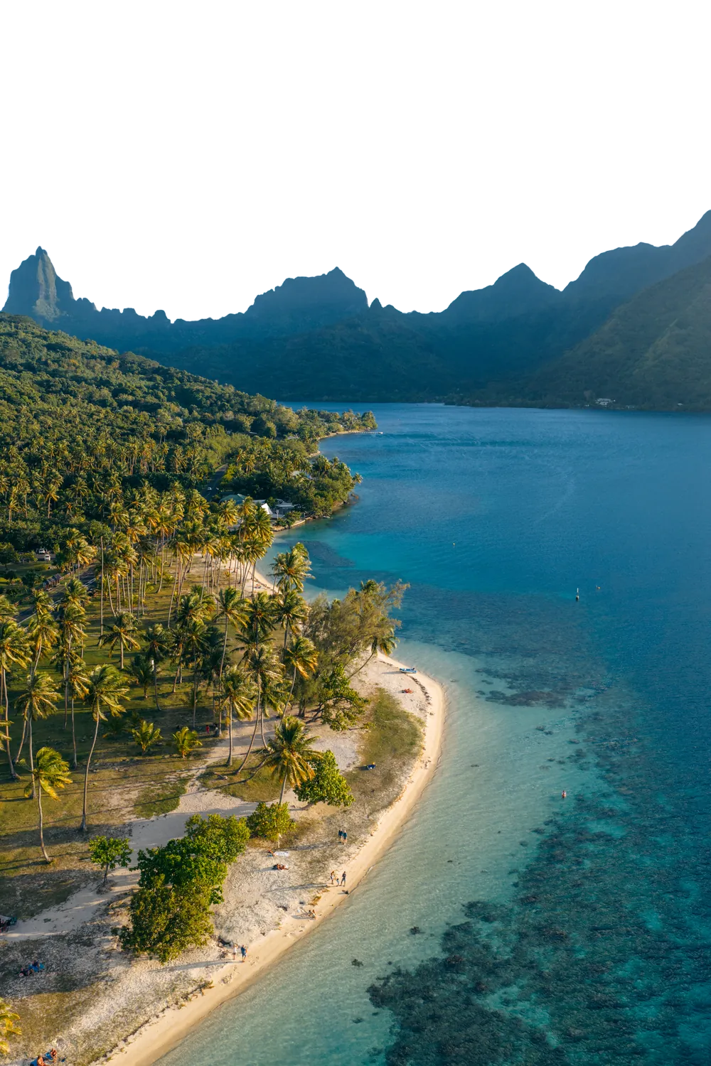 Mo'orea from the air: the needle peaks, a palm-lined white beach and the turquoise lagoon