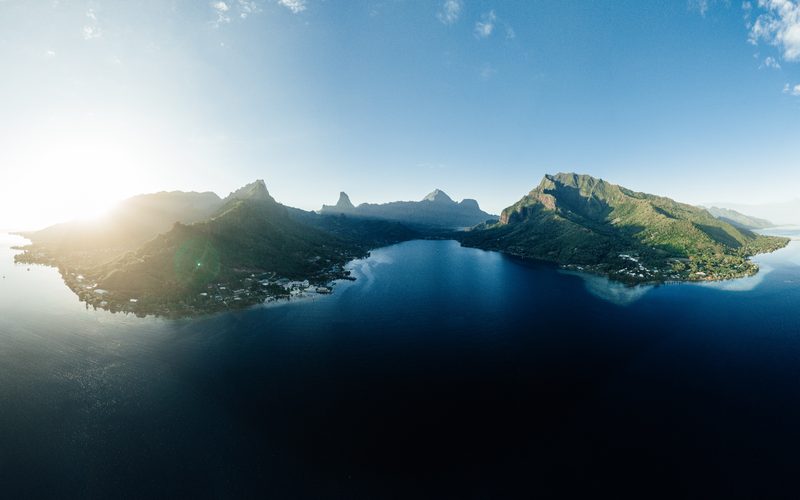 Aerial of Mo’orea at sunrise, both bays and the reef