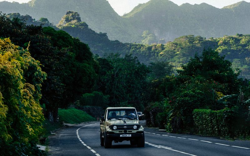 A road winding under Mo’orea’s peaks, a 4WD heading out